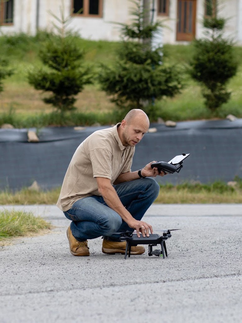 Drone operator preparing UAV for photogrammetry survey and 3D mapping